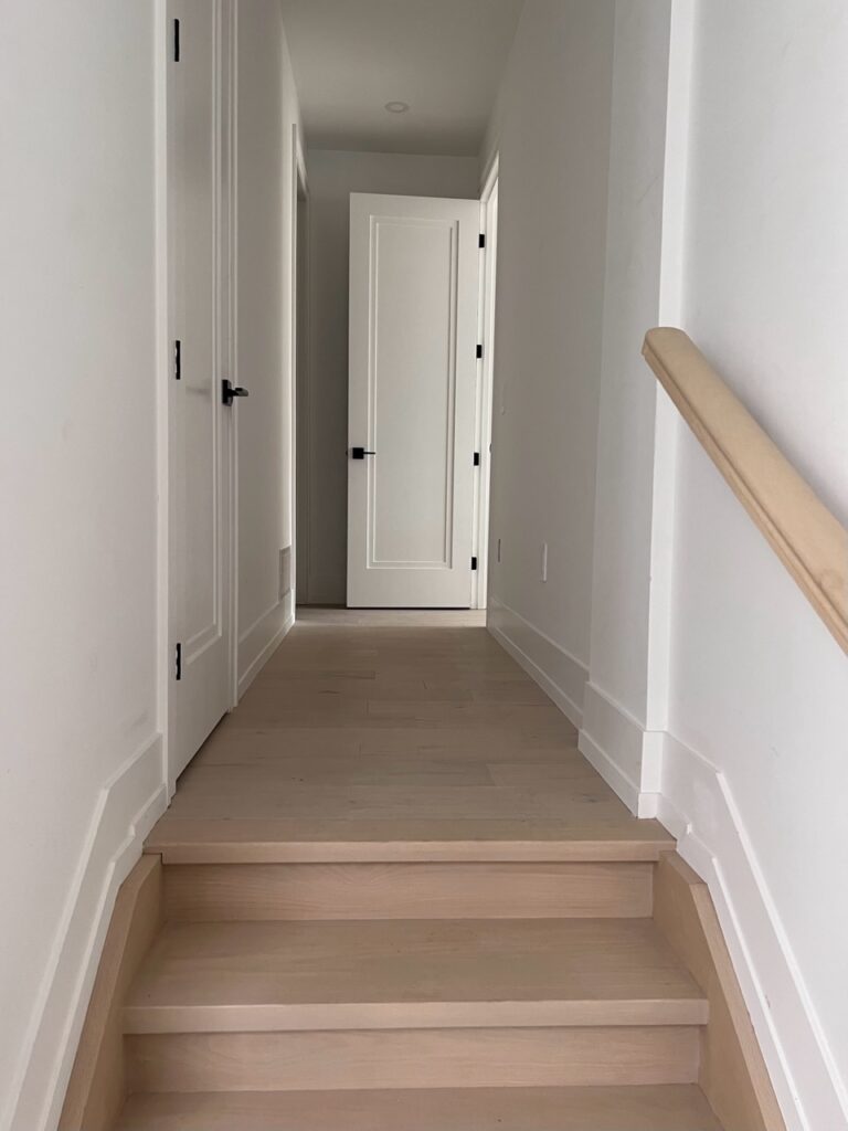 A corridor leading from a garage to the main floor.