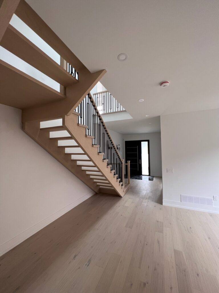 Large main entrance in a custom house with a set of stairs.