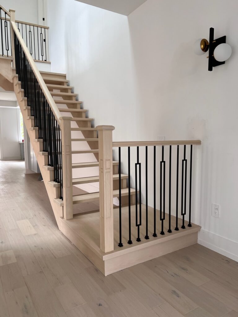 Main entry staircase with iron balusters.