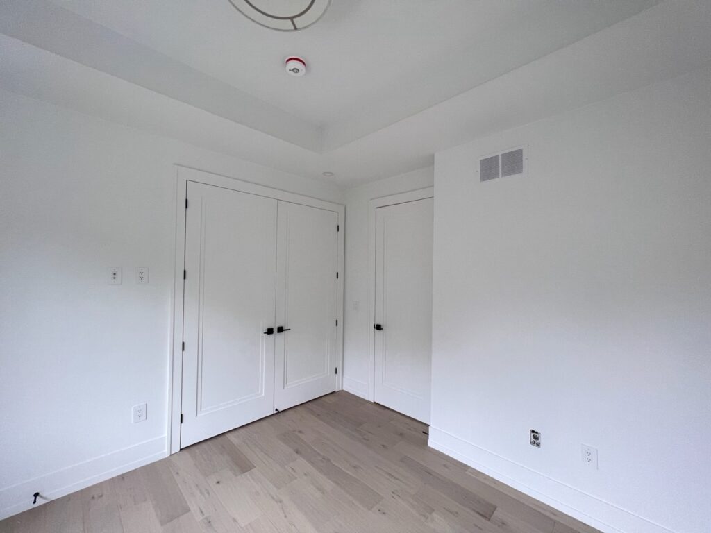 Spacious upstairs bedroom with a modern build-in closet.