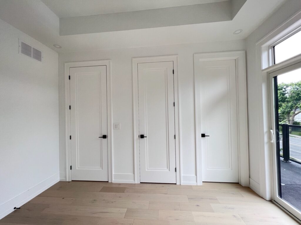 Closet doors painted white in a custom home.