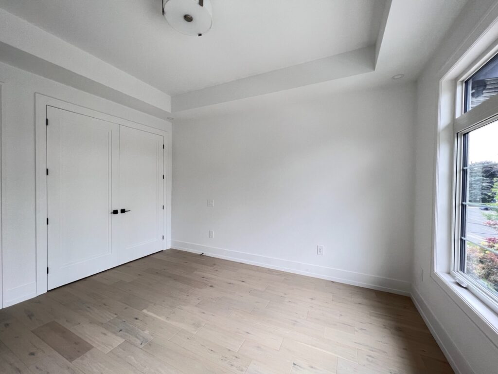White bedroom with a build-in modern closet.